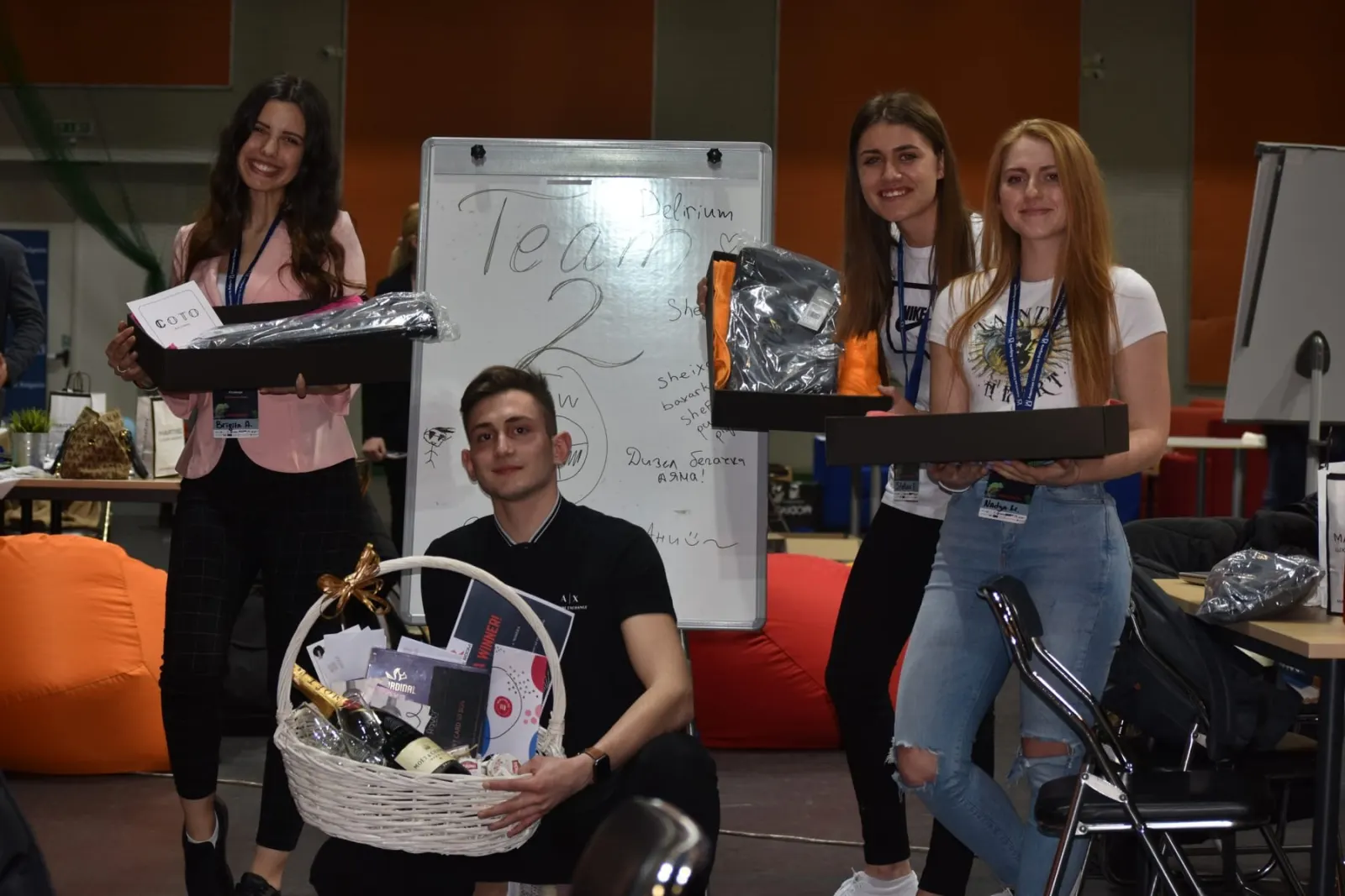 Winning team holding prizes in front of their flipchart